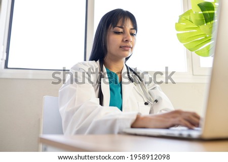 female doctor working with her computer