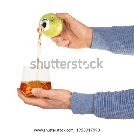 Green apple with faucet and apple juice streaming from it, concept of freshness and healthy diet