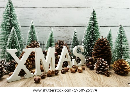 Merry XMAS Festive christmas background concept decoration with Christmas tree and pine cones on wooden background