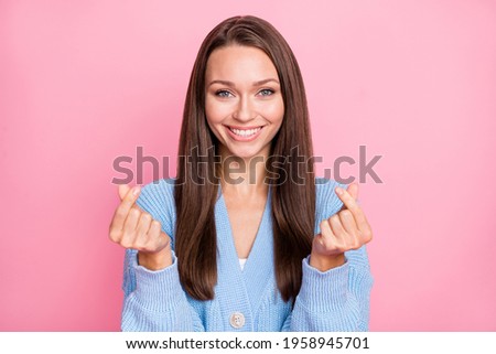 Photo of young woman happy positive smile show finger money cash sign isolated over pastel color background