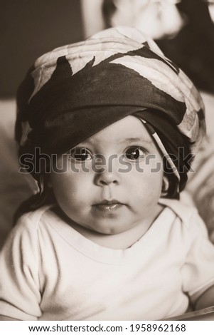 Image of cute little baby girl wearing turban 