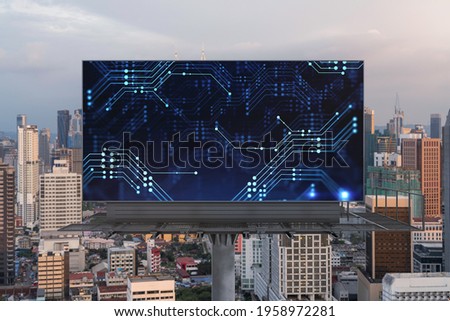 Glowing hologram of technological process on billboard, aerial panoramic cityscape of Kuala Lumpur at sunset. KL is the largest innovative hub of tech services in Malaysia, Asia.