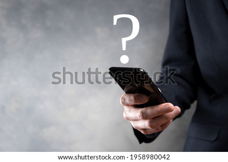 Businessman man hand hold interface question marks sign web. Ask quiestion online, FAQ concept, what where when how and why, search information on internet.