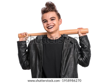 Rebellious teen boy dressed in black, isolated on white background. Young teenager in style of punk goth wearing leather jacket, holding wooden bat. Problems of transitional age