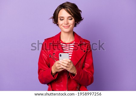 Photo of young cheerful girl happy positive smile look browse cellphone isolated over violet color background