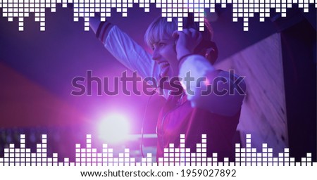 Composition on graphic music equalizer over smiling female dj playing music in club. entertainment, music and clubbing concept digitally generated image.