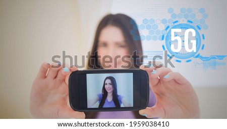 Composition of 5g text over scope scanning over woman showing photo of herself on smartphone. global networking, communication and digital interface concept digitally generated image