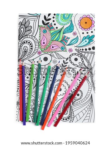 Antistress coloring page and pencils on white background, top view