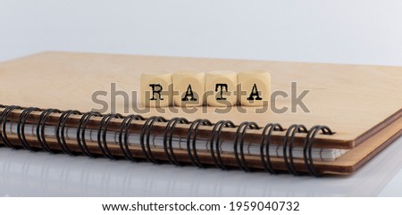 word RATA made with letters on the wooden blocks on wooden notepad