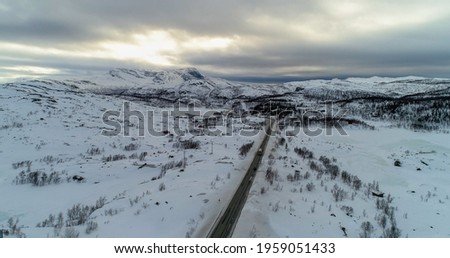 Tornetrask, aerial, rising, drone shot, towards a arctic lake, near Abisko, on a partly sunny day, in Lappland, Norrbotten, Sweden