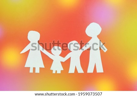 family made of paper, a symbol of a happy strong family, against the glare. children's Day, family day
