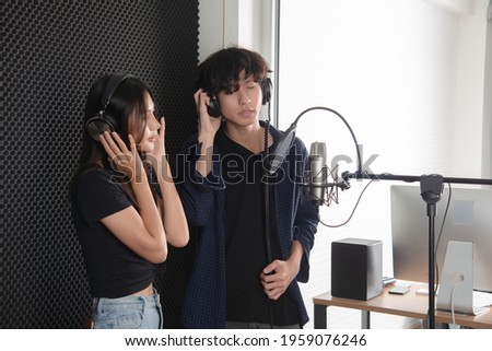teenage vocalist singing a song together in music studio record room