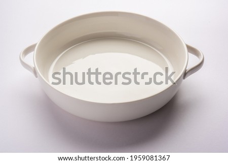 Empty white ceramic serving bowl, isolated over white or gray background Royalty-Free Stock Photo #1959081367