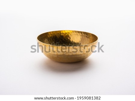 Empty Brass or golden metal bowl isolated over white background Royalty-Free Stock Photo #1959081382