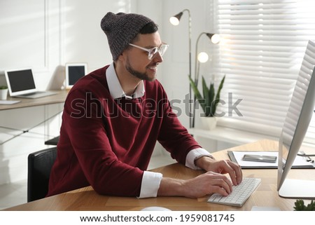 Freelancer working on computer at table indoors