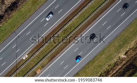 Aerial top down picture of three lane major highway traffic driving in both ways showing vehicles on all lanes