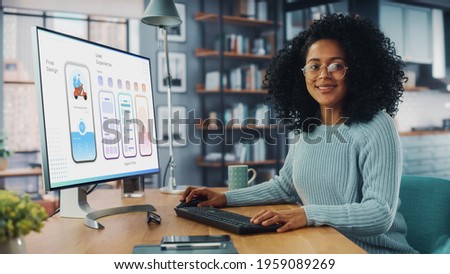Latina Female Specialist Working on Desktop Computer at Home Living Room while Sitting at a Table. Freelancer Developing New Food Delivery App Design, User interface in a Graphics Editing Software. Royalty-Free Stock Photo #1959089269
