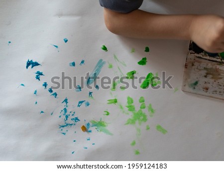Little child foxes paints on paper home activities