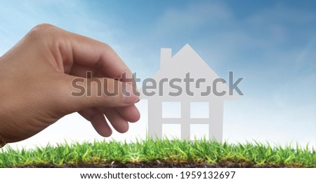 Hands holding paper house, family home and protecting insurance concept