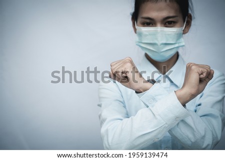 Girl wearing mask for protection from disease and show stop hands gesture for stop corona virus outbreak. Concept against coronavirus, COVID 19