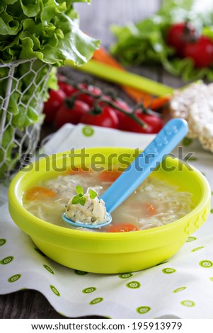 Chicken soup with meatballs served for children