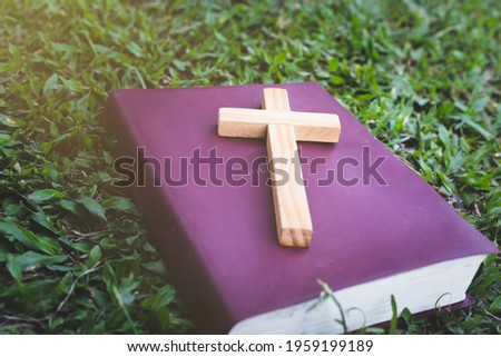 The cross is placed on the Bible. It was a wish from God. It represents forgiveness by the power of religion, faith, worship of the Christian thought.