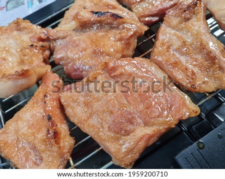 Close-up Grilled pork neck on a grill.