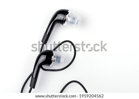 black wired headphones on a white background. vacuum headphones