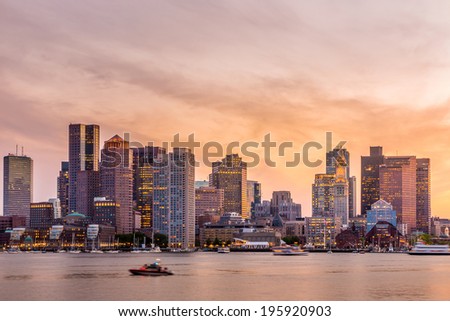 Boston downtown skyline panorama with skyscrapers over water at twilight