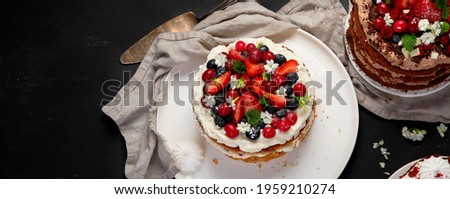Assorted delicious and colorful homemade cakes with different type of filling on black background. Panorama
