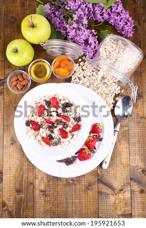 Healthy cereal with fruits on wooden table