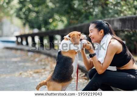 Woman and dog running and exercising outdoor in the park Royalty-Free Stock Photo #1959219043