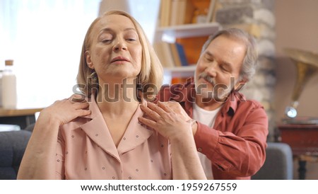 The bearded old man touches the shoulder of his sad wife, comforting him. She shares her sorrow with her husband, who hugs the blond old woman, and they hold each other's hands. The concept of sharing