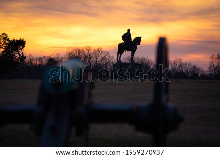 The Stonewall Jackson Monument at Manassas Battlefield National Park silhouetted at sunset.