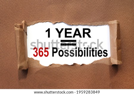 1 YEAR = 365 POSSIBILITIES. text inside torn brown paper. white sheet with black font