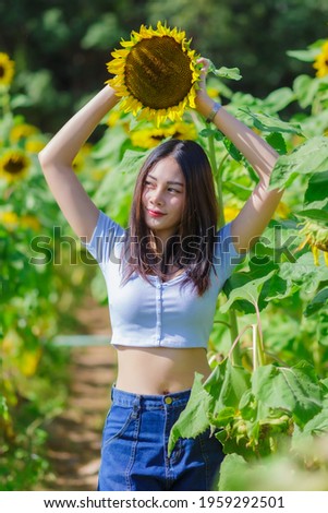 Beautyful Asian woman in the sunflower field.