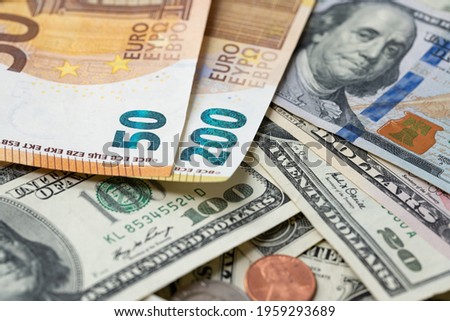200 Euro banknote next to 50 euros on top of one hundred dollar bills. Trading Euro with Dollar. Royalty-Free Stock Photo #1959293689
