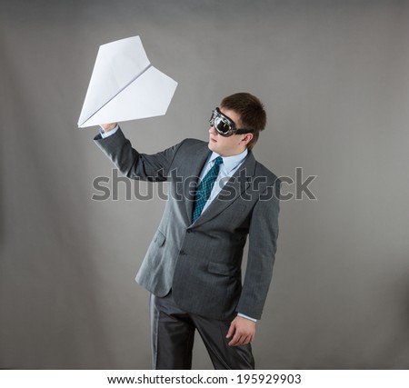 Businessman with paper plane and goggles