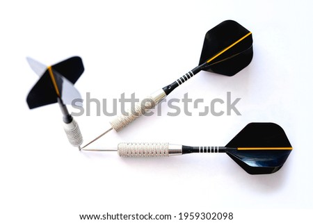 Three darts pointing the same target on an isolated white background. Straight to the aim of business concept.