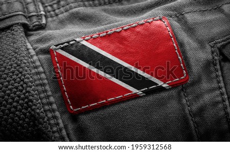 Tag on dark clothing in the form of the flag of the Trinidad and Tobago