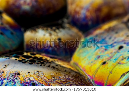 The colorful close-up surface of a soap bubble with weird psychedelic background and patterns.
Vivid rainbow colors in weird and strange patterns. 