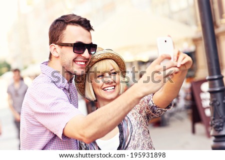 A picture of a happy couple taking a picture of themselves while sightseeing