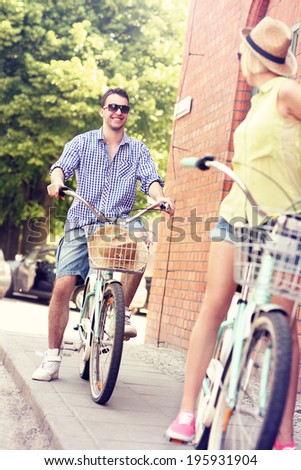 A picture of a young couple cycling in the city