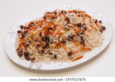 Afghani Pulao with traditional topping. Royalty-Free Stock Photo #1959337876