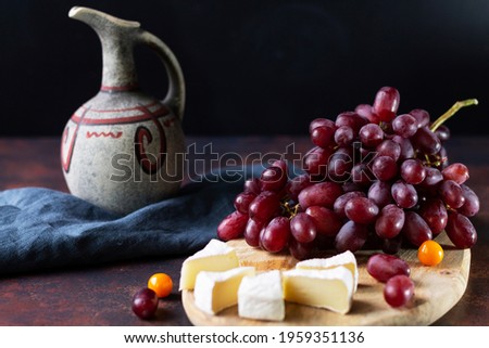 Still life with a bunch of grapes on a dark background with a copy of the space. Close-up. Space for text