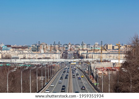 Russia, Moscow, April 10, 2021. Panorama of Moscow, Luzhniki Bridge, cars driving on the road, blue sky. 