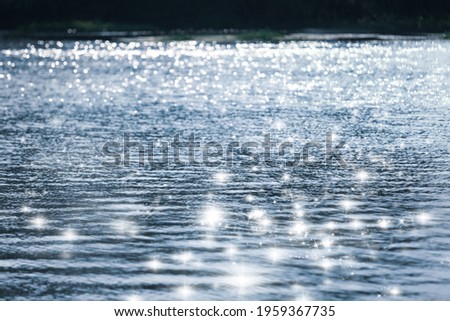 Blurry water wave ripple with  bright abstract bokeh of sun ligh.Nature background. Royalty-Free Stock Photo #1959367735
