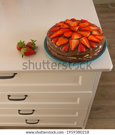 delicious strawberry cake with chocolate on a white marble table