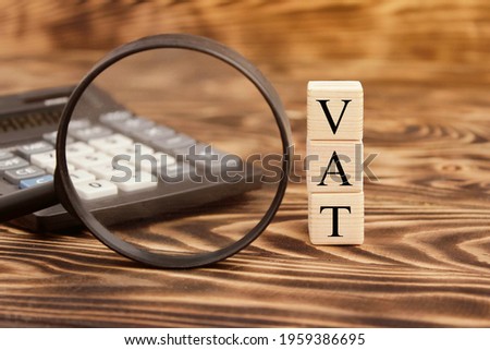 VAT letters (or Value Added Tax) on business card shown by a man. High quality photo