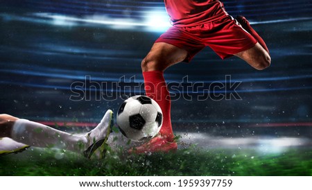 Close up of a football action scene with competing soccer players at the stadium Royalty-Free Stock Photo #1959397759